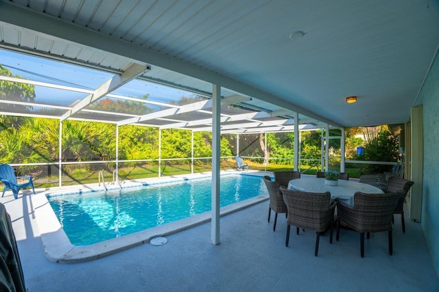 view of swimming pool featuring a patio and a lanai