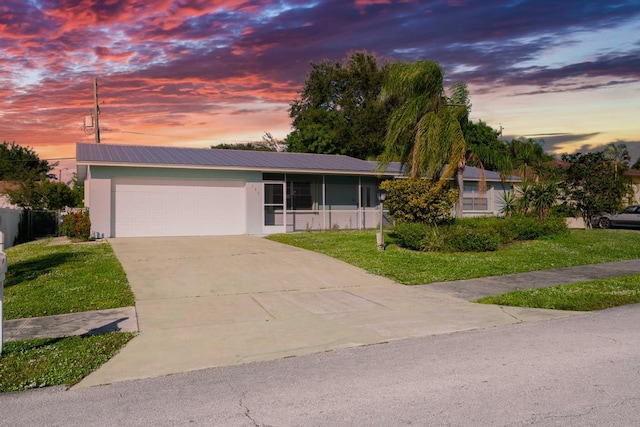 view of front of home featuring a yard and a garage