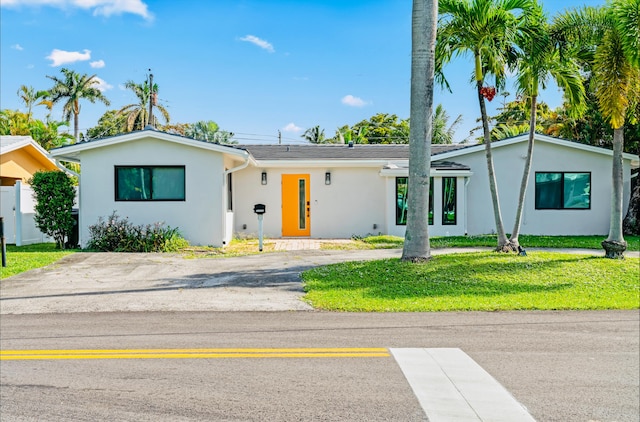 ranch-style home with a front lawn