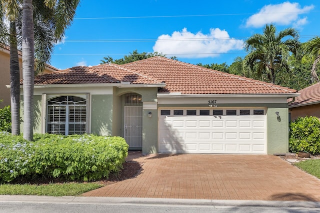 mediterranean / spanish-style home featuring a garage