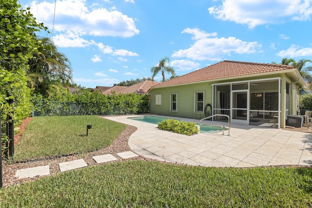 view of pool featuring a patio, a lawn, and a sunroom