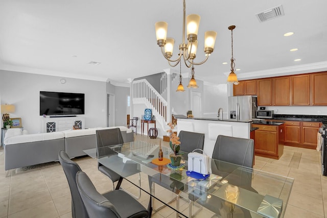 dining room with sink, light tile patterned flooring, a chandelier, and ornamental molding