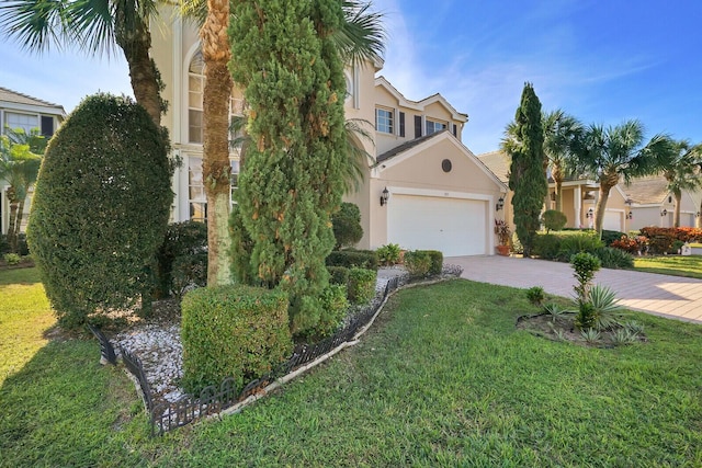 view of front of house with a garage and a front lawn