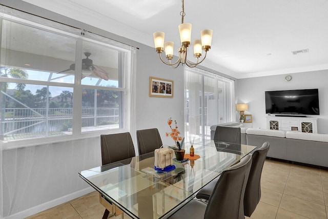 tiled dining space featuring ceiling fan with notable chandelier and ornamental molding