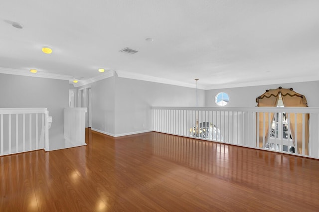 bonus room with hardwood / wood-style floors and a notable chandelier