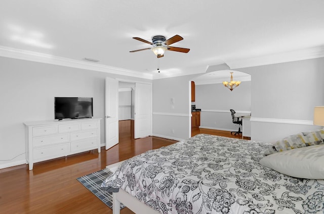 bedroom with ceiling fan with notable chandelier, dark hardwood / wood-style floors, and ornamental molding