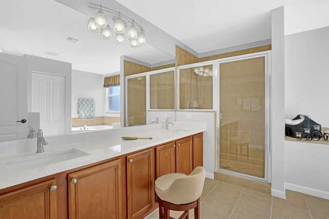 bathroom featuring tile patterned flooring, vanity, and walk in shower