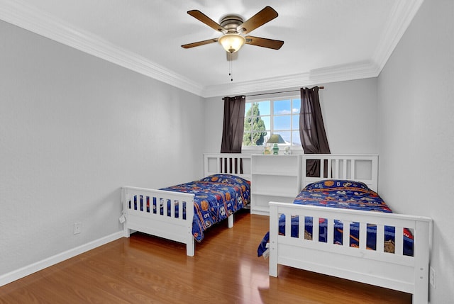 bedroom with wood-type flooring, ceiling fan, and crown molding