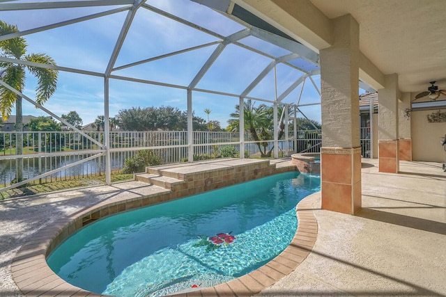 view of swimming pool with a water view, a patio area, ceiling fan, and a lanai