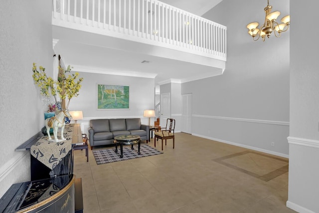 living room featuring a towering ceiling, a notable chandelier, and ornamental molding