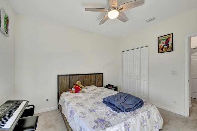 bedroom with light colored carpet and ceiling fan