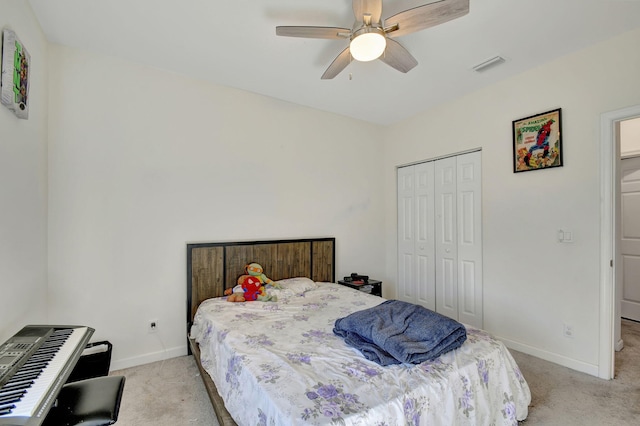 bedroom featuring ceiling fan, a closet, and light colored carpet