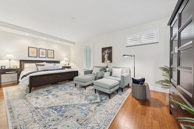 bedroom featuring wood-type flooring and multiple windows