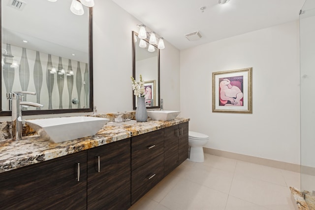 bathroom featuring tile patterned flooring, vanity, and toilet