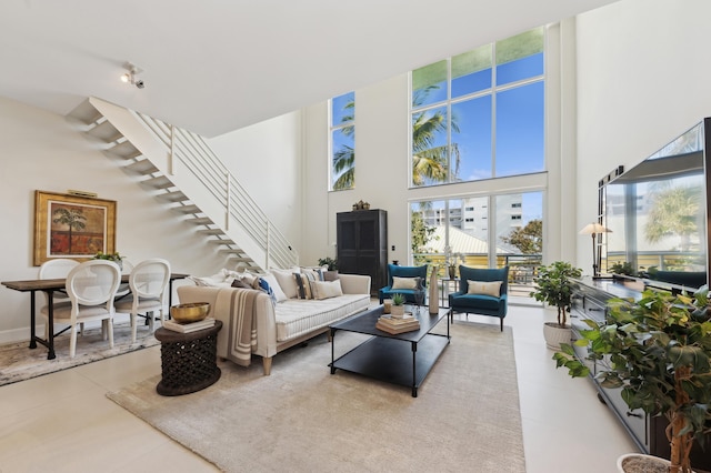 tiled living room with a towering ceiling