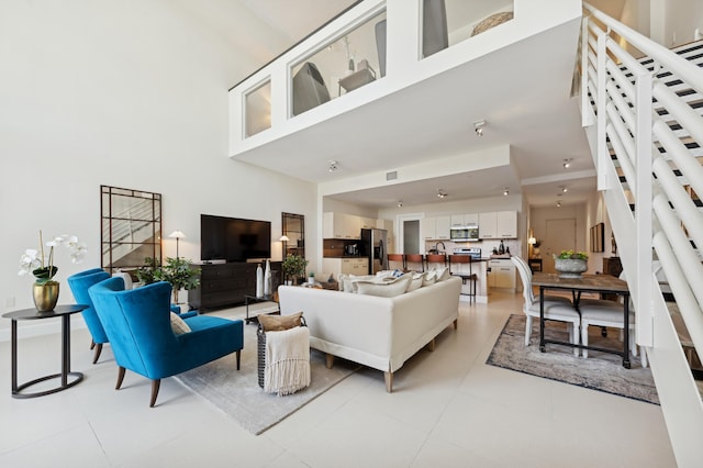 tiled living room with a towering ceiling