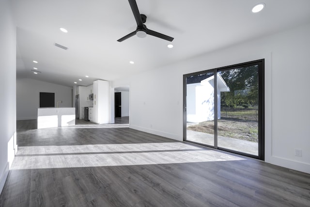 unfurnished living room with ceiling fan, dark hardwood / wood-style flooring, and vaulted ceiling