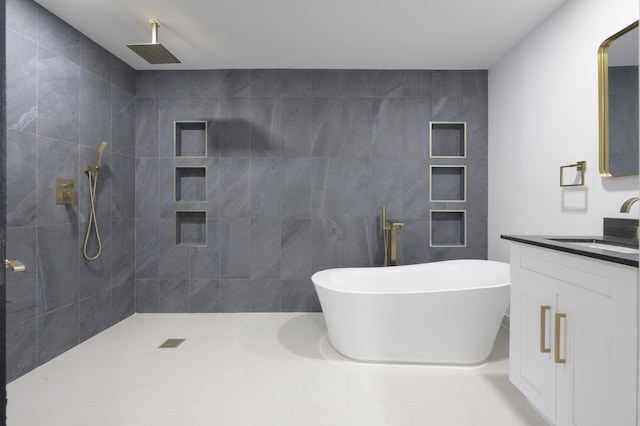 bathroom featuring tile patterned flooring, vanity, separate shower and tub, and tile walls