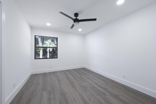 empty room with ceiling fan and dark wood-type flooring