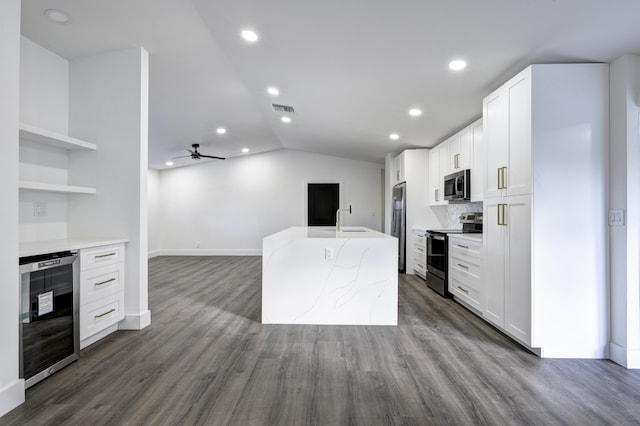 kitchen with appliances with stainless steel finishes, dark hardwood / wood-style flooring, ceiling fan, white cabinets, and wine cooler