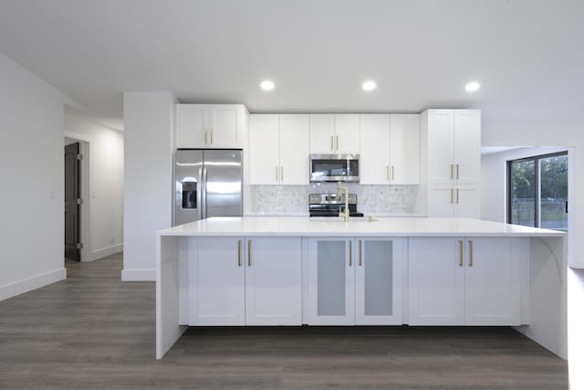 kitchen featuring dark hardwood / wood-style flooring, white cabinetry, and appliances with stainless steel finishes