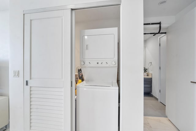 laundry room with stacked washer / dryer