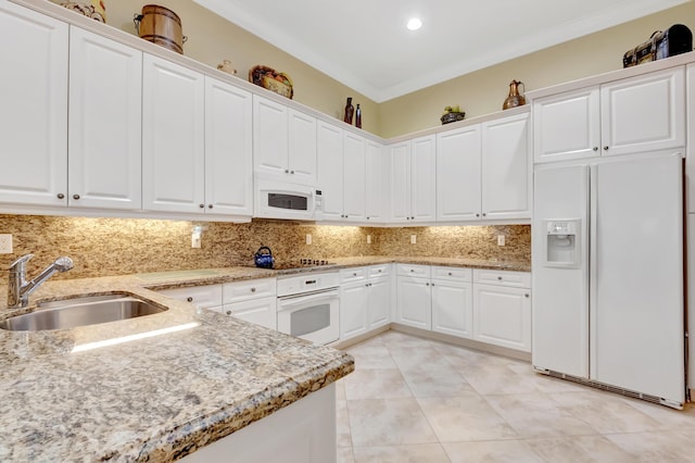 kitchen featuring white appliances, backsplash, white cabinets, crown molding, and sink