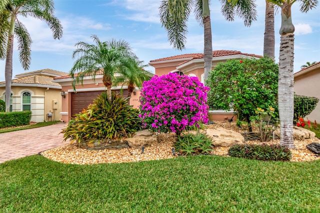 view of front of property featuring a garage and a front lawn