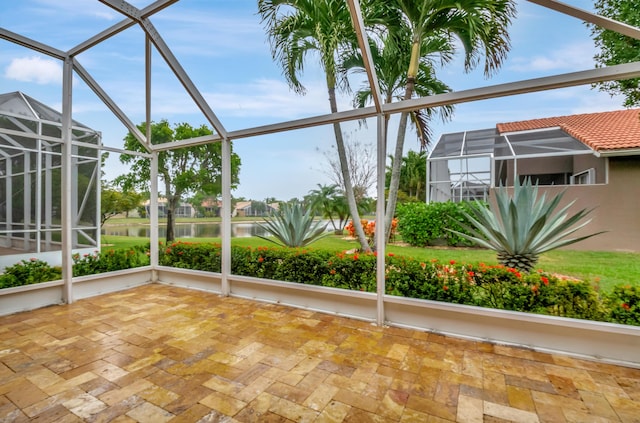 unfurnished sunroom with a water view and a wealth of natural light