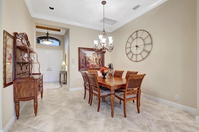 dining room featuring ornamental molding and an inviting chandelier