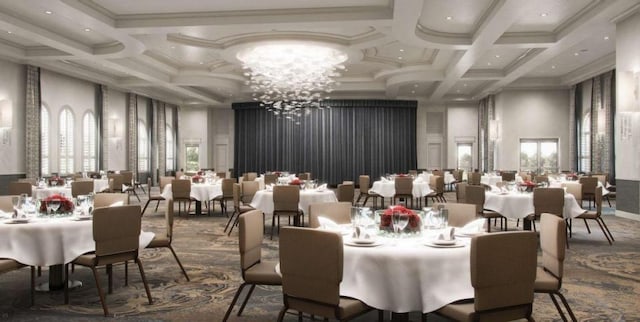 interior space featuring plenty of natural light, a chandelier, coffered ceiling, and ornamental molding