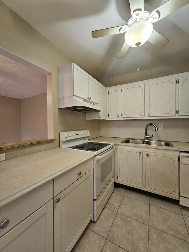 kitchen featuring white appliances, ceiling fan, sink, white cabinetry, and light tile patterned flooring