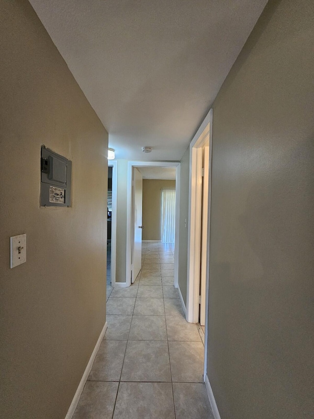 hall featuring light tile patterned floors