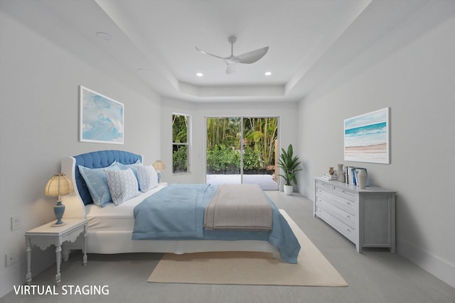 bedroom featuring light carpet, a raised ceiling, and ceiling fan