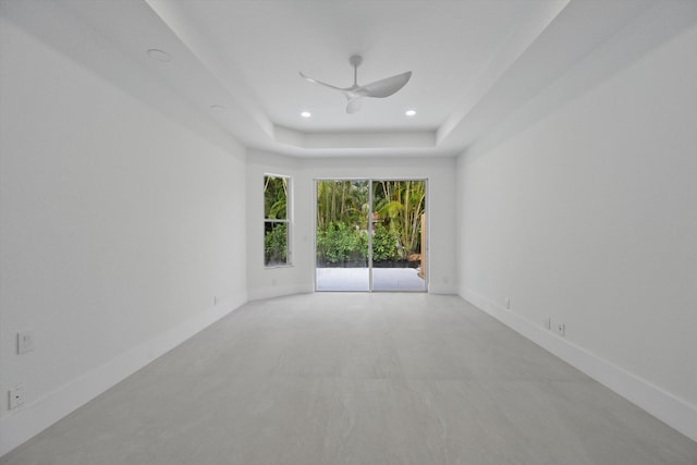 unfurnished room with a tray ceiling and ceiling fan