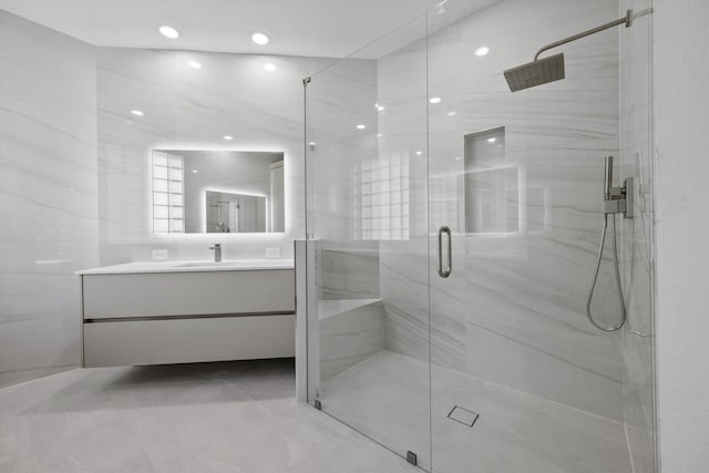 bathroom featuring vanity and a shower with door