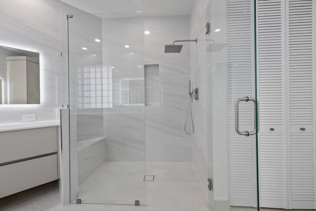 bathroom featuring vanity and an enclosed shower