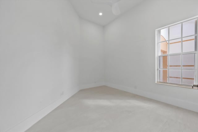 spare room featuring ceiling fan and carpet floors