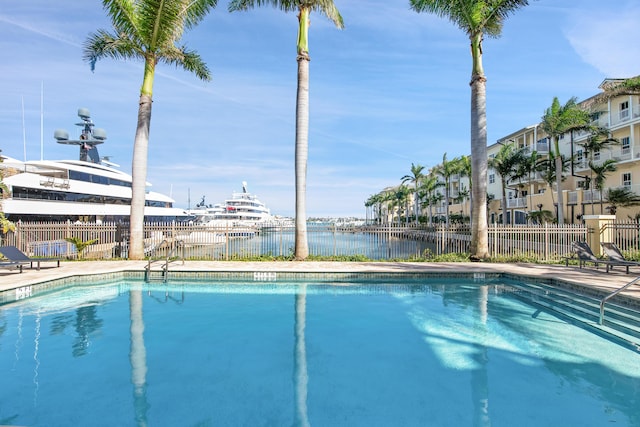 view of swimming pool featuring a water view