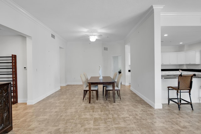 tiled dining area featuring crown molding and ceiling fan