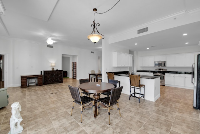 dining room with light tile patterned floors, ceiling fan, and ornamental molding