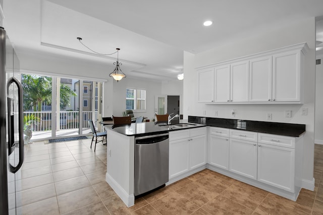 kitchen featuring white cabinetry, sink, hanging light fixtures, kitchen peninsula, and appliances with stainless steel finishes