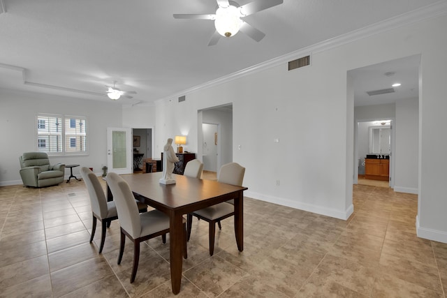 dining space featuring crown molding, ceiling fan, and light tile patterned flooring