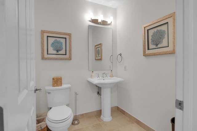 bathroom with tile patterned flooring and toilet