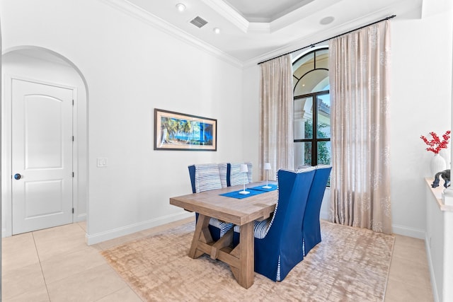 tiled dining room featuring crown molding