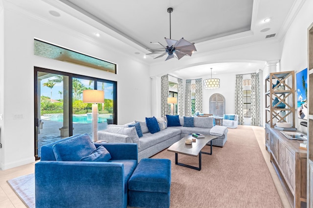 tiled living room featuring ceiling fan, ornate columns, and ornamental molding