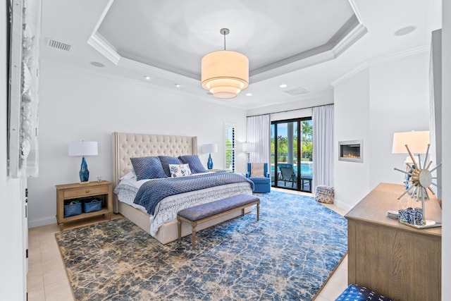 bedroom with a raised ceiling, access to exterior, light tile patterned floors, and ornamental molding