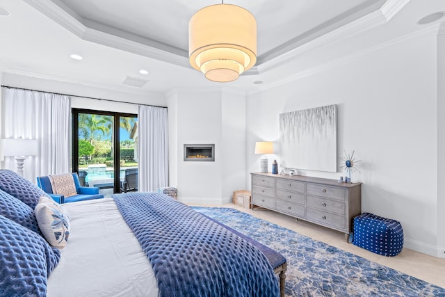 tiled bedroom with access to exterior, a raised ceiling, and crown molding