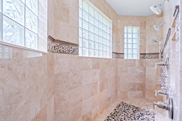 bathroom featuring tile walls and tiled shower