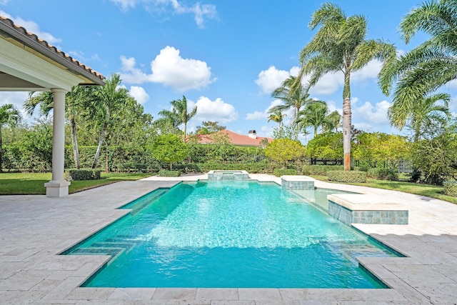 view of pool with an in ground hot tub, pool water feature, and a patio area